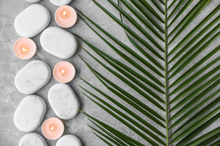 Flat lay composition with spa stones and candles on gray marble backgroundの写真素材