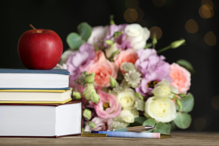Composition with flowers and books on wooden table. Teacher's dayの写真素材