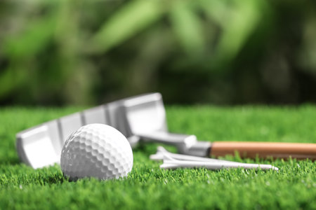 Set of golf equipment on green artificial grassの写真素材