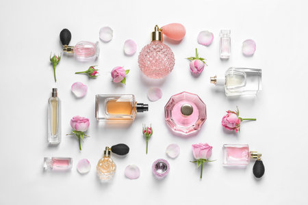 Different perfume bottles and flowers on white background, top viewの写真素材