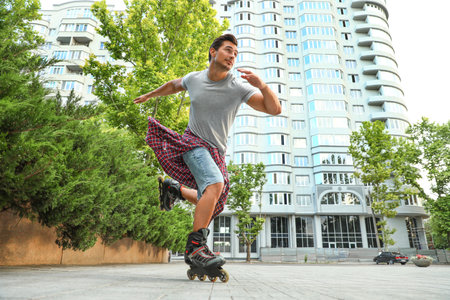 Handsome young man roller skating outdoors. recreational activityの写真素材