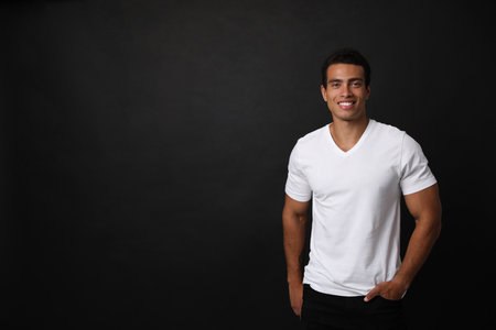 Handsome young African-American man on black background. Space for textの写真素材