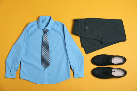 Flat lay composition with school uniform on yellow backgroundの写真素材