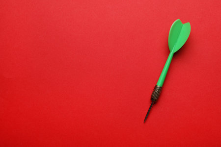 Green dart arrow on red background, top view with space for textの写真素材