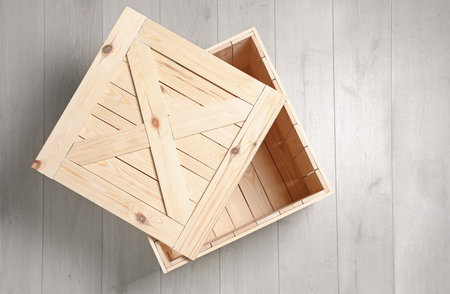 Open wooden crate on floor, top view