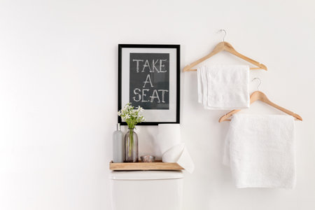 Decor elements, necessities and toilet bowl near white wall, space for text. bathroom interior