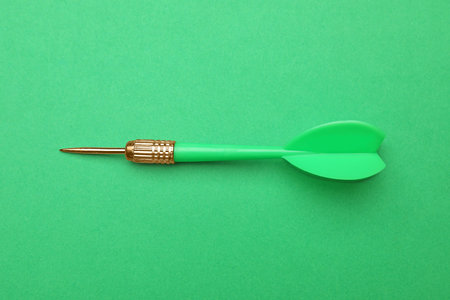 Plastic dart arrow on green background, top viewの写真素材