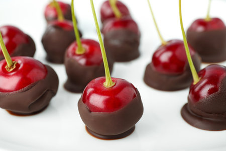 Chocolate dipped cherries on white background, closeupの写真素材