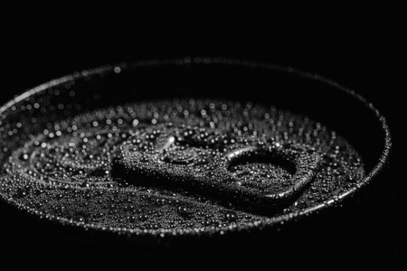Aluminum can of beverage covered with water drops on black background, closeupの写真素材