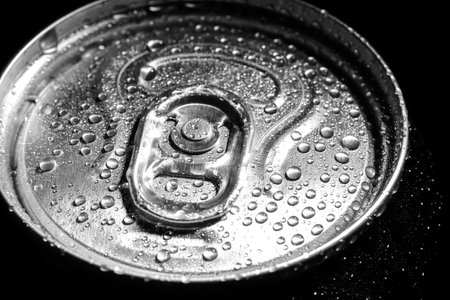 Aluminum can of beverage covered with water drops on black background, closeupの写真素材