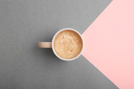Cup of coffee on color background, top viewの写真素材
