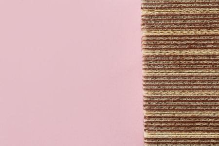 Tasty wafer sticks on pink background, flat lay with space for text. sweet foodの写真素材