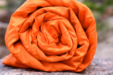 Rolled sleeping bag outdoors on sunny day, closeupの写真素材