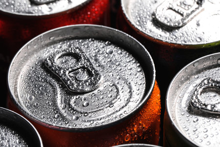 Aluminum cans of beverage covered with water drops as background, closeupの写真素材