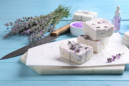 Hand made soap bars with lavender flowers on light blue wooden tableの写真素材