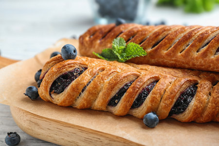 Fresh delicious puff pastry with sweet berries served on white wooden table, closeupの写真素材