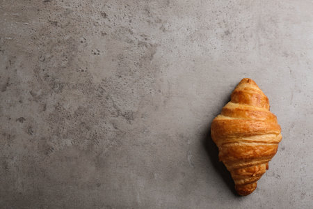 Tasty croissant and space for text on gray background, top view. french pastryの写真素材