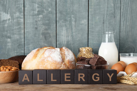 Different products on wooden background. food allergy conceptの写真素材