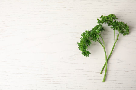 Fresh green parsley on white wooden table, flat lay. Space for textの写真素材