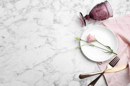 Elegant table setting on marble table, flat lay. Space for textの写真素材