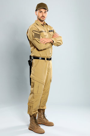 Male security guard in uniform on gray backgroundの写真素材