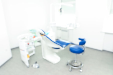 Blurred view of dentist's office interior with chair and equipmentの写真素材