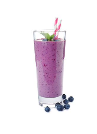 Glass of delicious blueberry smoothie with mint and straw on white backgroundの写真素材
