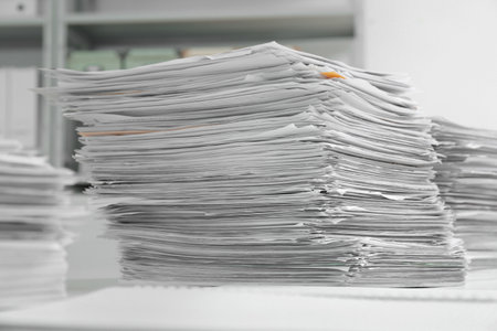 Stacks of documents on table in officeの写真素材