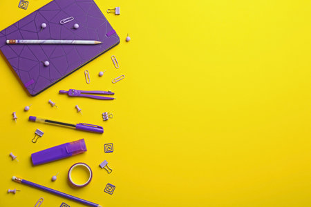Purple school stationery on yellow background, flat lay. Space for textの写真素材