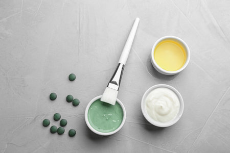 Flat lay composition with freshly made spirulina facial mask on light gray tableの写真素材