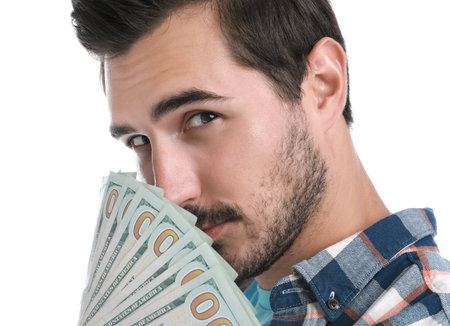 Handsome young man with dollars on white backgroundの写真素材