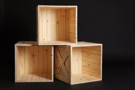 Group of wooden crates on black backgroundの写真素材