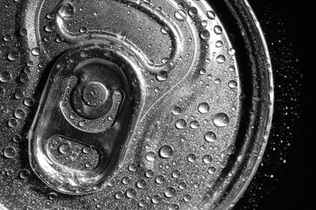 Aluminum can of beverage covered with water drops on black background, top viewの写真素材