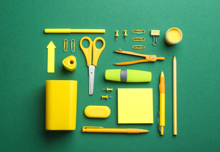 Bright school stationery on green background, flat layの写真素材