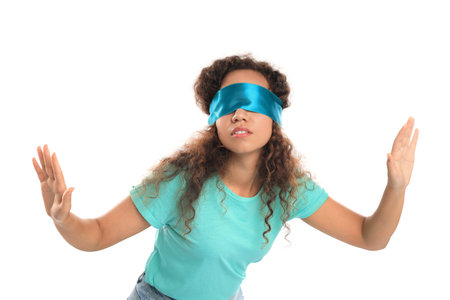 Young African-American woman with light blue blindfold on white backgroundの写真素材