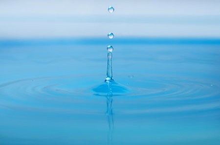 Splash of blue water with drop, closeupの写真素材