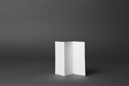 Blank brochure on dark gray background. Mock up designの写真素材