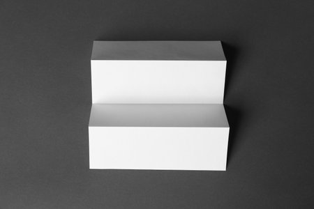 Blank brochure on dark gray background, top view. Mock up designの写真素材
