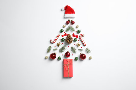 Christmas tree silhouette of fir branches and festive decoration on white background, top viewの写真素材