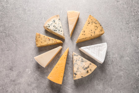 Flat lay composition with different kinds of cheese on gray backgroundの写真素材