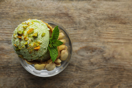 Delicious green ice cream served on wooden table, top view. Space for textの写真素材