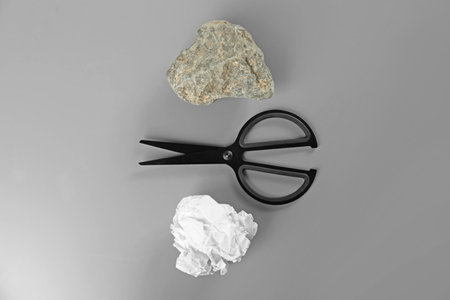 Flat lay composition with rock, paper and scissors on gray backgroundの写真素材