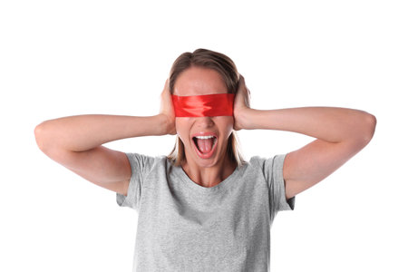 Young woman wearing red blindfold on white backgroundの写真素材