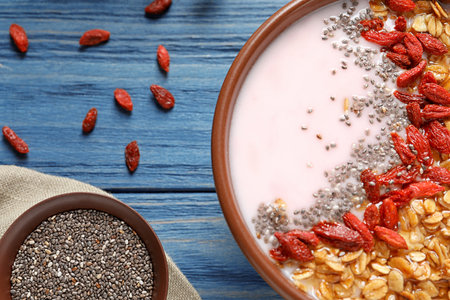Smoothie bowl with goji berries on blue wooden table, closeupの写真素材