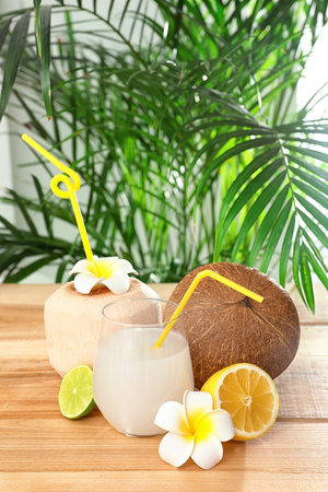 Composition with glass of coconut water on wooden table against blurred backgroundの写真素材