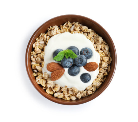 Bowl of tasty oatmeal with blueberries, yogurt and almond on white background, top viewの写真素材