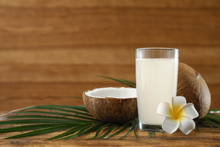 Composition with glass of coconut water on wooden background. Space for textの写真素材