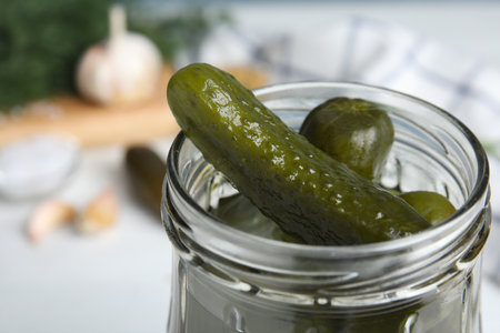 Jar with pickled cucumbers on table, closeup viewの写真素材