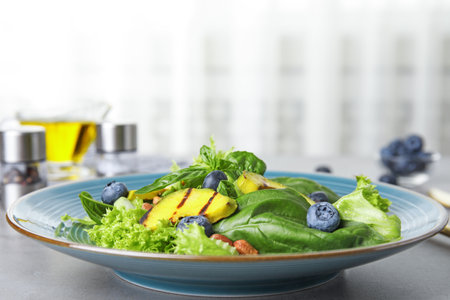 Delicious avocado salad with blueberries on grey tableの写真素材