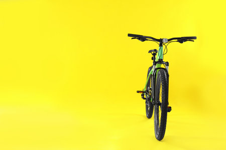 Modern bicycle on yellow background. Space for textの写真素材